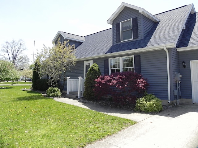 view of property exterior with a lawn and roof with shingles