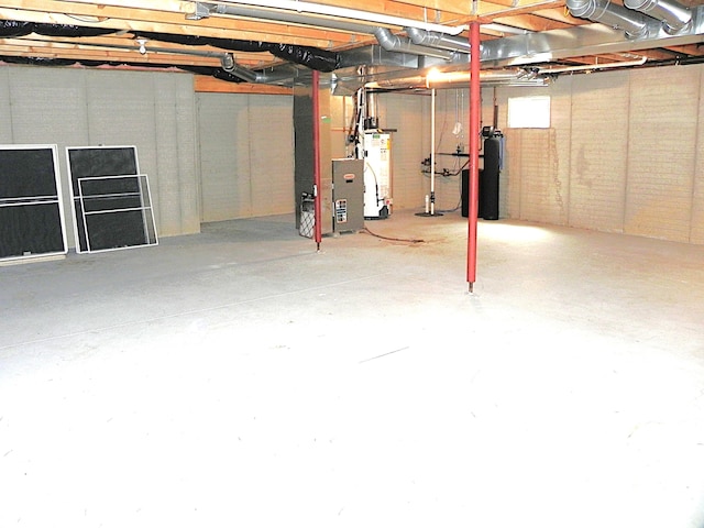 unfinished below grade area featuring water heater