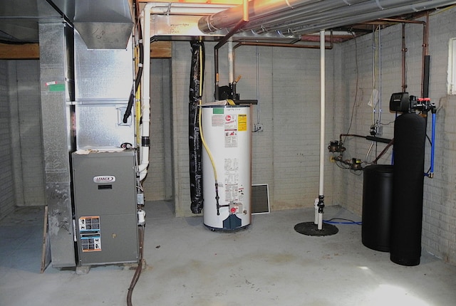 utility room featuring heating unit and gas water heater