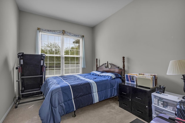 bedroom featuring baseboards and light carpet