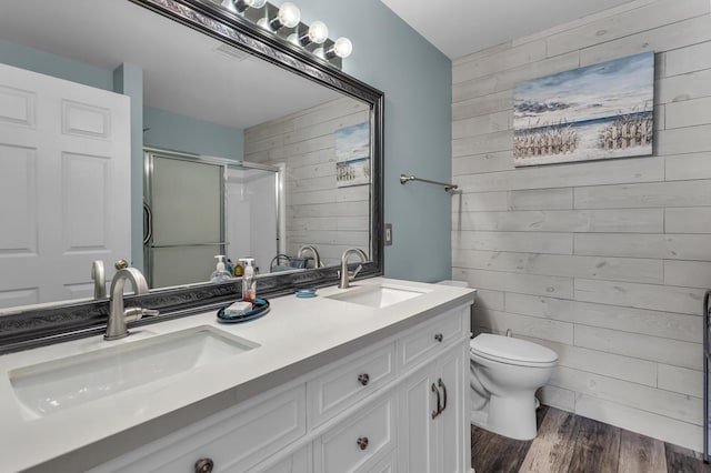 full bathroom with a sink, wooden walls, and a shower stall