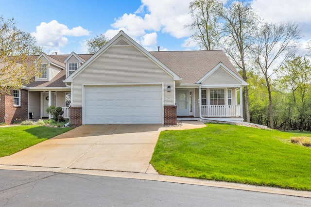 view of front of house with covered porch, a front yard, brick siding, an attached garage, and driveway