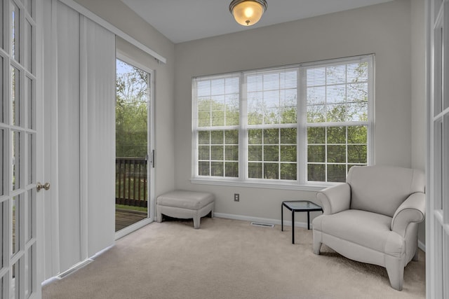living area with baseboards, carpet flooring, and visible vents
