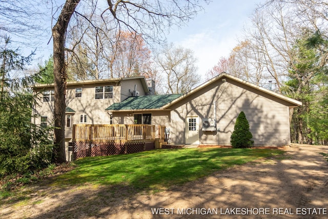 3087 38th St, Hamilton, MI 49419 - back of property with a lawn and a wooden deck