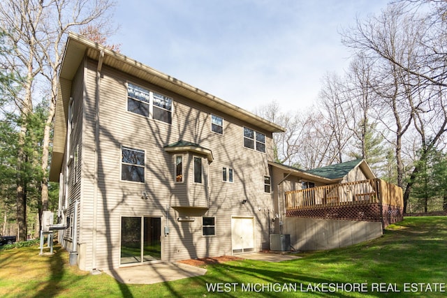 3087 38th St, Hamilton, MI 49419 - back of house featuring a lawn, central air condition unit, and a deck