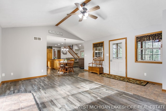 3087 38th St, Hamilton, MI 49419 - foyer with lofted ceiling with beams, ceiling fan with notable chandelier, baseboards, wood finished floors, and visible vents