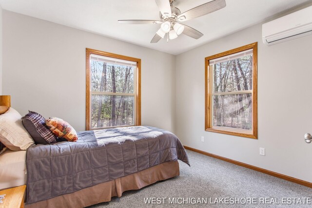 3087 38th St, Hamilton, MI 49419 - carpeted bedroom featuring baseboards, a ceiling fan, and a wall mounted AC