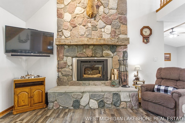 3087 38th St, Hamilton, MI 49419 - living room featuring ceiling fan, a stone fireplace, wood finished floors, and lofted ceiling