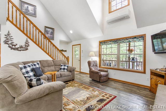 3087 38th St, Hamilton, MI 49419 - living room featuring a wall mounted air conditioner, wood finished floors, high vaulted ceiling, baseboards, and stairs