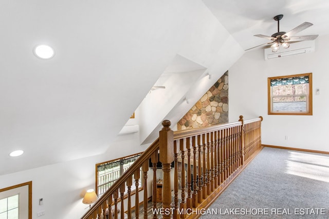 3087 38th St, Hamilton, MI 49419 - corridor with carpet flooring, a wall mounted air conditioner, baseboards, an upstairs landing, and lofted ceiling