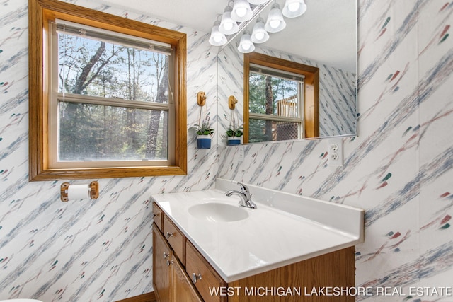 3087 38th St, Hamilton, MI 49419 - bathroom with wallpapered walls and vanity