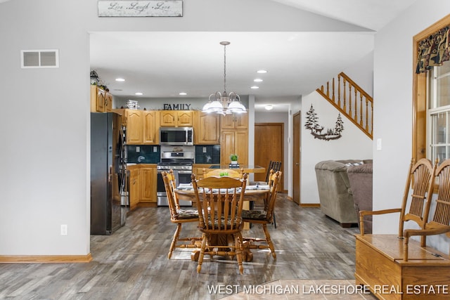 3087 38th St, Hamilton, MI 49419 - dining area with an inviting chandelier, baseboards, wood finished floors, and visible vents