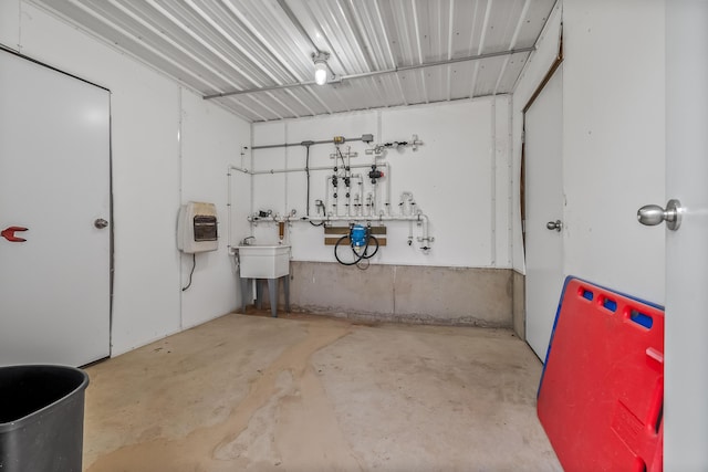 garage featuring heating unit and a workshop area