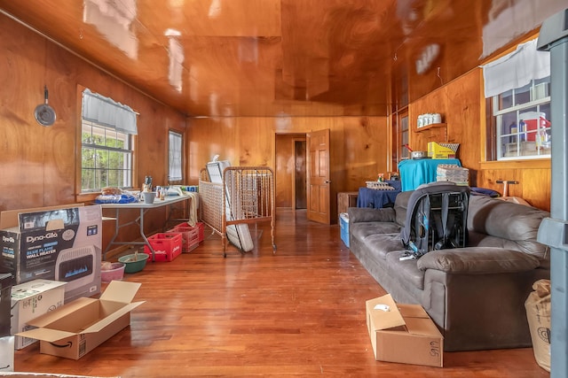 living area featuring wooden ceiling, wood walls, and wood finished floors