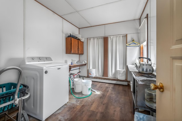 clothes washing area featuring a baseboard heating unit, washer / dryer, and wood finished floors