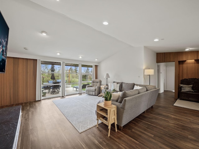living room with recessed lighting, dark wood finished floors, and lofted ceiling