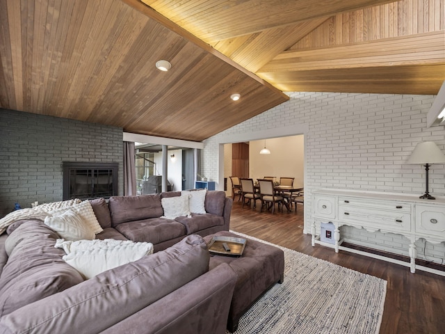 living room featuring a fireplace, dark wood-style floors, brick wall, and lofted ceiling