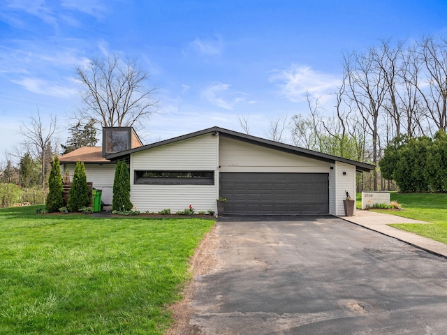 view of front of house with driveway, a front yard, and a garage