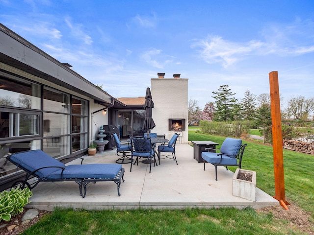 view of patio featuring an outdoor brick fireplace