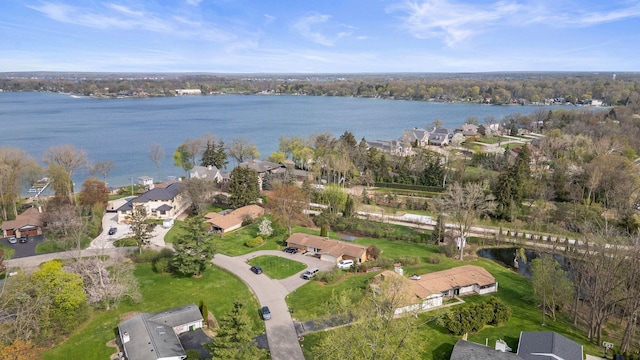 drone / aerial view featuring a water view and a residential view