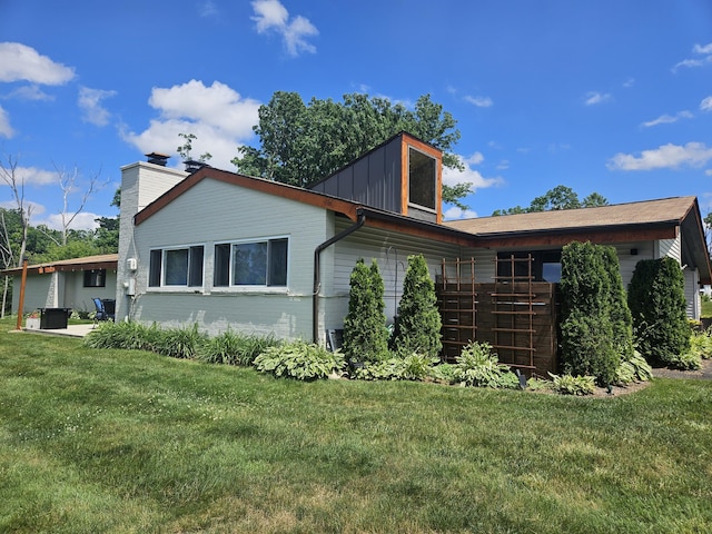 2330 N Pine Center Dr, West Bloomfield, MI 48323 - view of property exterior with a yard, a garage, a chimney, and board and batten siding