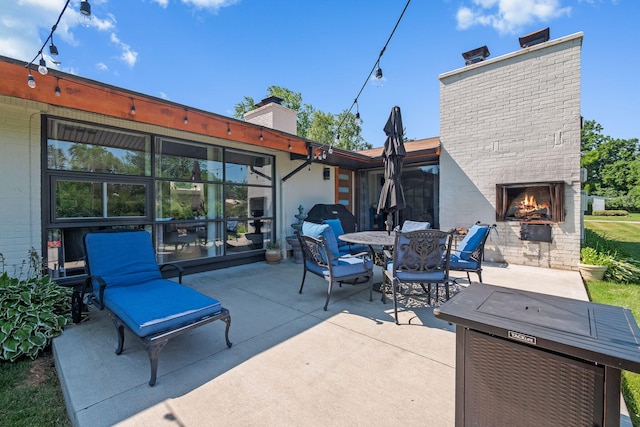 2330 N Pine Center Dr, West Bloomfield, MI 48323 - view of patio featuring an outdoor brick fireplace and outdoor dining space