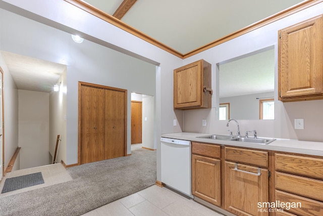 kitchen featuring light countertops, white dishwasher, light colored carpet, and a sink