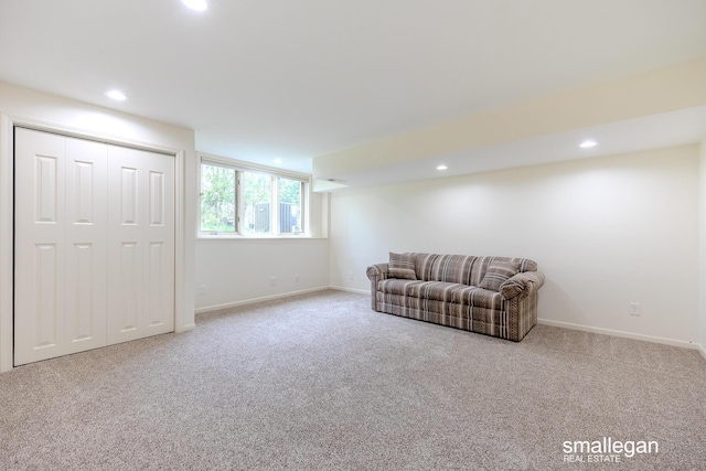 carpeted living area with recessed lighting and baseboards