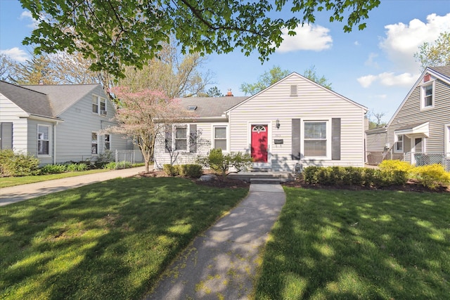 view of front of home featuring a chimney and a front lawn