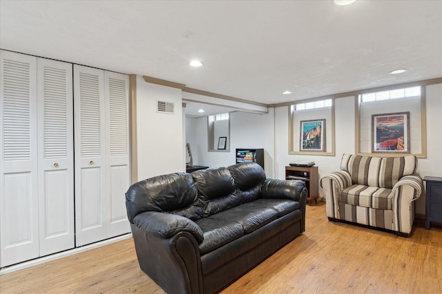 living area with recessed lighting, light wood finished floors, and visible vents