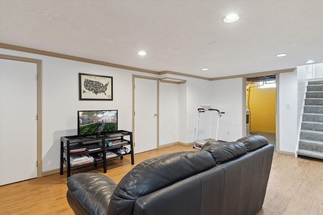 living area with stairway, crown molding, light wood-style floors, and recessed lighting