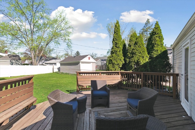 wooden terrace with fence, an outdoor structure, and a yard