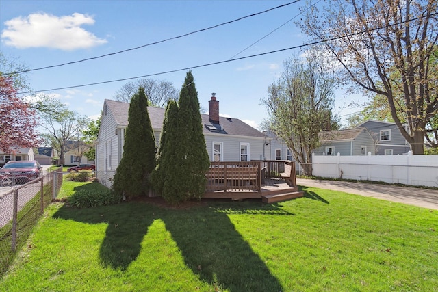 view of yard featuring a wooden deck and a fenced backyard