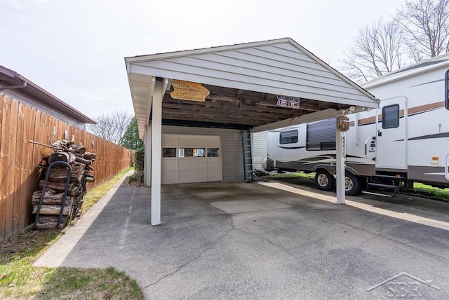 4438 N Verity Rd, Sanford, MI 48657 - view of car parking featuring a garage, aphalt driveway, and fence