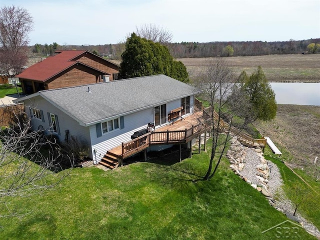 4438 N Verity Rd, Sanford, MI 48657 - rear view of property with a lawn, roof with shingles, and a deck with water view