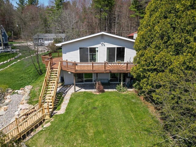 4438 N Verity Rd, Sanford, MI 48657 - back of property with a lawn, stairs, and a deck