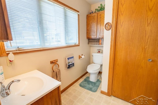 4438 N Verity Rd, Sanford, MI 48657 - bathroom featuring baseboards, tile patterned floors, toilet, and vanity