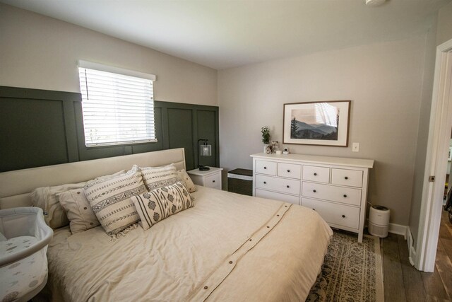 bedroom with dark wood-type flooring