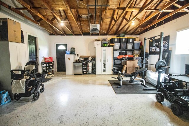 garage with fridge and a garage door opener