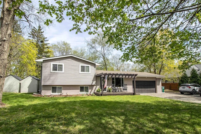 split level home with fence, a pergola, an attached garage, a front yard, and driveway