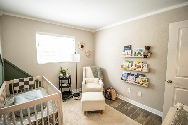 bedroom featuring baseboards, ornamental molding, and wood finished floors