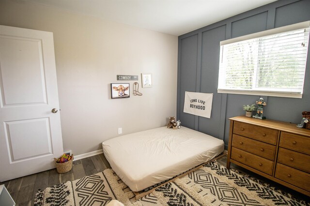 bedroom featuring dark wood-style flooring