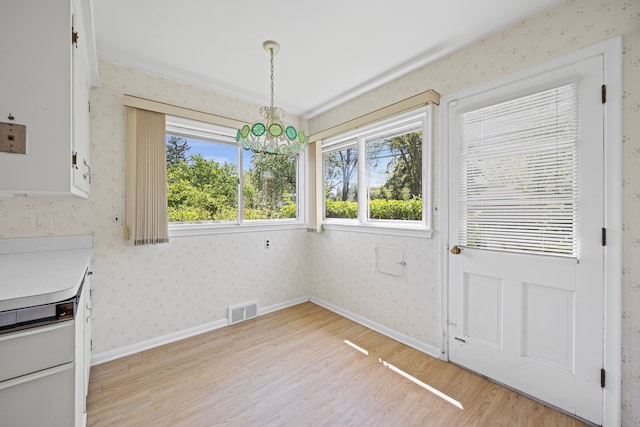 605 S Higbie Pl, Grosse Pointe Woods, MI 48236 - unfurnished dining area with light wood-style floors, a chandelier, wallpapered walls, and baseboards