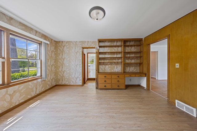 605 S Higbie Pl, Grosse Pointe Woods, MI 48236 - empty room with wallpapered walls, light wood-style floors, and baseboards