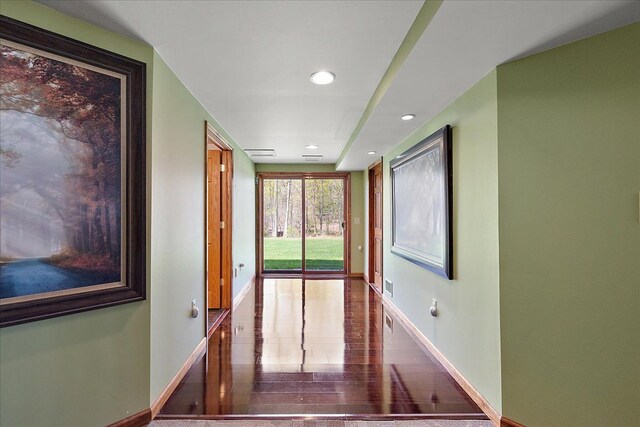 hallway featuring baseboards, recessed lighting, and visible vents