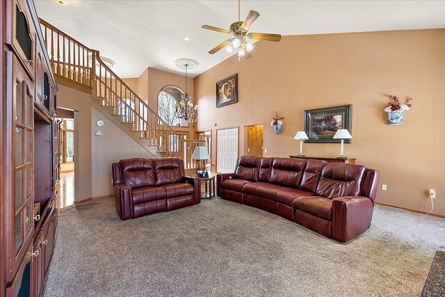 living area featuring carpet floors, baseboards, high vaulted ceiling, and stairway