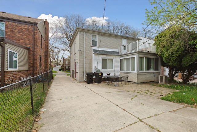17172 Huntington Rd, Detroit, MI 48219 - back of house with brick siding, central AC unit, fence, and a balcony