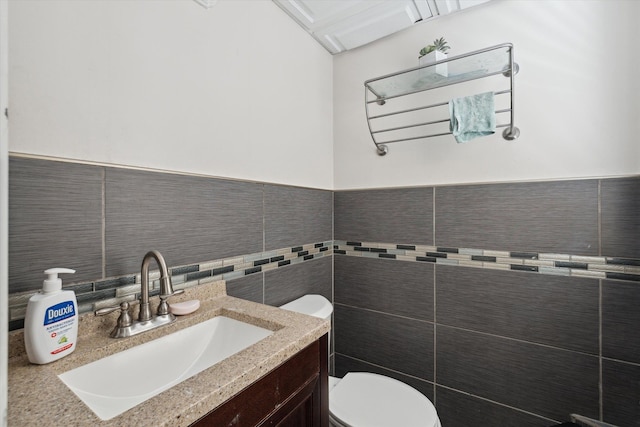 17172 Huntington Rd, Detroit, MI 48219 - half bath with vanity, a wainscoted wall, toilet, and tile walls