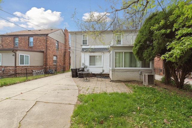 17172 Huntington Rd, Detroit, MI 48219 - back of house with fence, central AC unit, a patio area, and brick siding