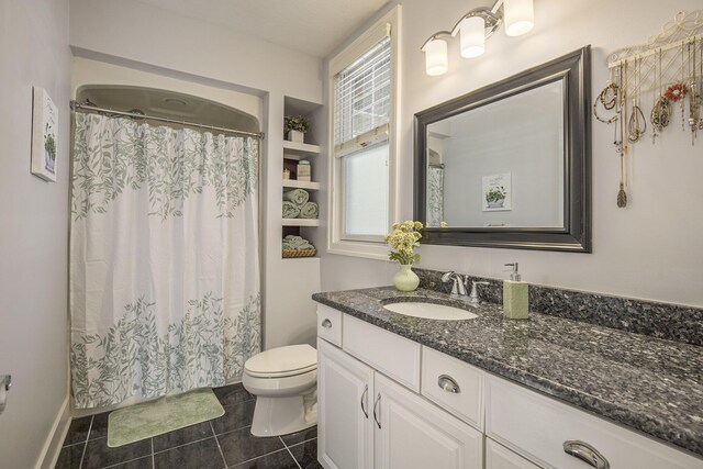 bathroom featuring vanity, tile patterned floors, a shower with curtain, and toilet